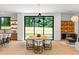 Dining room featuring a wooden table, modern light fixture, and floor to ceiling windows overlooking the backyard at 16 Bonnie Ln, Atlanta, GA 30328
