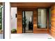 Exterior entrance featuring natural wood accents, modern tiling, and black trimmed windows at 16 Bonnie Ln, Atlanta, GA 30328