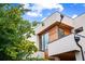Corner view of a home featuring neutral exterior, wood accents, modern gutters, and mature landscaping at 16 Bonnie Ln, Atlanta, GA 30328