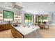 Open concept kitchen with center island, wood cabinets, and backyard views at 16 Bonnie Ln, Atlanta, GA 30328