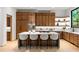 Modern kitchen with wood cabinets, island with seating, and stainless steel appliances at 16 Bonnie Ln, Atlanta, GA 30328