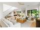 Open-concept living room with a modern design, light wood floors, and access to outdoor spaces at 16 Bonnie Ln, Atlanta, GA 30328
