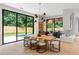 Living room featuring a modern fireplace and floor to ceiling windows overlooking the backyard at 16 Bonnie Ln, Atlanta, GA 30328