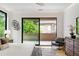 Relaxing main bedroom featuring neutral decor, a ceiling fan, and a balcony at 16 Bonnie Ln, Atlanta, GA 30328