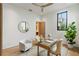 Stylish home office with a modern desk, two white chairs, contemporary rug, and natural lighting at 16 Bonnie Ln, Atlanta, GA 30328