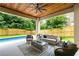 Covered patio featuring outdoor seating area, ceiling fan, and view of the pool at 16 Bonnie Ln, Atlanta, GA 30328
