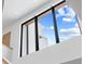 Large window showcasing a bright blue sky, and the home's modern design at 16 Bonnie Ln, Atlanta, GA 30328