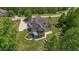Top down view of home showcasing mature landscaping, stone terracing, large deck, and screened in porch at 893 Somersby Dr, Dallas, GA 30157