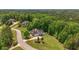 Overhead of property with verdant landscape, mature trees, and homes nestled within a well-spaced community at 893 Somersby Dr, Dallas, GA 30157