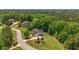 This aerial shows a home nestled among lush green trees in a quiet, desirable neighborhood at 893 Somersby Dr, Dallas, GA 30157