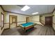 Basement game room with vinyl plank flooring, pool table, and easy access to other rooms at 893 Somersby Dr, Dallas, GA 30157