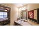 Half bath featuring single vanity, large floral art piece on the wall, and neutral tan color scheme at 893 Somersby Dr, Dallas, GA 30157