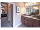 Bathroom vanity with cherry wood cabinets, marble countertop and a rectangular mirror at 893 Somersby Dr, Dallas, GA 30157