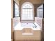 Bathroom with a garden tub, tile surround, and a large window at 893 Somersby Dr, Dallas, GA 30157