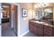 Bathroom featuring tan cabinets, granite countertops, and large vanity mirror at 893 Somersby Dr, Dallas, GA 30157