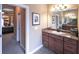 Bathroom features a vanity with marble countertop, decorative mirror, and tile floor at 893 Somersby Dr, Dallas, GA 30157