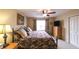 Bedroom featuring an iron bed frame, decorative pillows, and ample natural light from the window at 893 Somersby Dr, Dallas, GA 30157