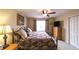 Comfortable bedroom with patterned bedding, a ceiling fan, and a large window at 893 Somersby Dr, Dallas, GA 30157