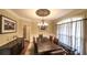 Spacious dining room with stylish chandelier, hardwood floors, and ample seating for dinner guests at 893 Somersby Dr, Dallas, GA 30157