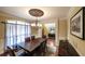 Elegant dining room with dark wood table, stylish chandelier, and view to adjacent living area at 893 Somersby Dr, Dallas, GA 30157