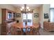 Cozy dining room with wood table, chairs, chandelier, and sideboard for ample storage and serving at 893 Somersby Dr, Dallas, GA 30157