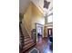 Elegant foyer with soaring ceilings, a grand chandelier, hardwood floors, and staircase with iron railing at 893 Somersby Dr, Dallas, GA 30157