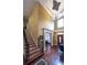 Grand foyer with soaring ceilings, hardwood floors, elegant staircase, and decorative lighting creating a welcoming entrance at 893 Somersby Dr, Dallas, GA 30157
