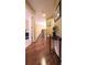 Hallway showing hardwood flooring, an ornate staircase, and decorative accent table at 893 Somersby Dr, Dallas, GA 30157