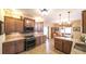 Spacious kitchen with granite countertops, tile flooring, and wood cabinetry connected to the dining area at 893 Somersby Dr, Dallas, GA 30157