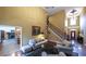 Spacious living room with fireplace, elegant staircase, and comfortable seating arrangement for entertaining at 893 Somersby Dr, Dallas, GA 30157