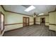 Spacious living room with hardwood floors, large windows, and a ceiling fan at 893 Somersby Dr, Dallas, GA 30157
