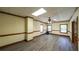 Bright, large living room with hardwood floors, and windows, lit by a ceiling fan at 893 Somersby Dr, Dallas, GA 30157
