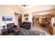 Cozy living room flowing into the kitchen and dining areas, with a leather sofa and open layout perfect for entertaining at 893 Somersby Dr, Dallas, GA 30157