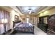 Well-lit main bedroom features tray ceilings, plush carpeting, and stylish furniture at 893 Somersby Dr, Dallas, GA 30157