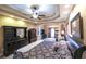 Luxurious main bedroom with tray ceilings, sitting area, and decorative furnishings at 893 Somersby Dr, Dallas, GA 30157