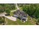 An aerial of the back of the home showing the deck, patio, and oversized driveway with garage access at 893 Somersby Dr, Dallas, GA 30157