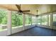 Bright sunroom featuring vaulted ceilings, ceiling fans and multiple windows with wooded views at 893 Somersby Dr, Dallas, GA 30157