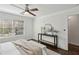 Bright bedroom with a ceiling fan and modern table underneath a rounded mirror at 1833 Flat Shoals Se Rd, Atlanta, GA 30316