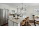 Modern kitchen featuring white cabinets, granite counters, an island with seating, and stainless steel appliances at 1833 Flat Shoals Se Rd, Atlanta, GA 30316