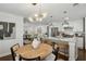Open concept kitchen flows to dining area with white cabinetry, island seating, and hardwood floors at 1833 Flat Shoals Se Rd, Atlanta, GA 30316