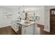 Eat-in kitchen showcasing granite countertops, stainless steel appliances, a breakfast bar, and hardwood flooring at 1833 Flat Shoals Se Rd, Atlanta, GA 30316