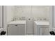 Functional laundry room with a side by side washer and dryer, plus wire shelving for storage at 1833 Flat Shoals Se Rd, Atlanta, GA 30316