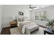 Serene main bedroom with a tufted headboard, bench, neutral decor, and hardwood floors at 1833 Flat Shoals Se Rd, Atlanta, GA 30316