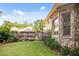 Fenced backyard showcasing lush green lawn, plantings along the home's exterior, and brick exterior details at 208 Grandmar, Canton, GA 30115