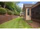 Well-maintained backyard features lush lawn, stepping stones, and mature landscaping for outdoor enjoyment at 208 Grandmar, Canton, GA 30115