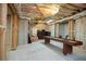 Unfinished basement featuring exposed ceiling and a shuffleboard game, offering potential for customization at 208 Grandmar, Canton, GA 30115