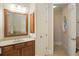 Well-lit bathroom with a vanity, large mirror, and access to the hallway and toilet at 208 Grandmar, Canton, GA 30115