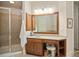 Well-lit bathroom with a walk-in shower, wood vanity, and large mirror at 208 Grandmar, Canton, GA 30115