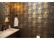 Chic powder room featuring gray walls adorned with pineapple wallpaper and a stylish mirror and faucet at 208 Grandmar, Canton, GA 30115