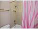 Bathroom featuring a shower with pink striped curtain, a toilet, and a shelf niche at 208 Grandmar, Canton, GA 30115
